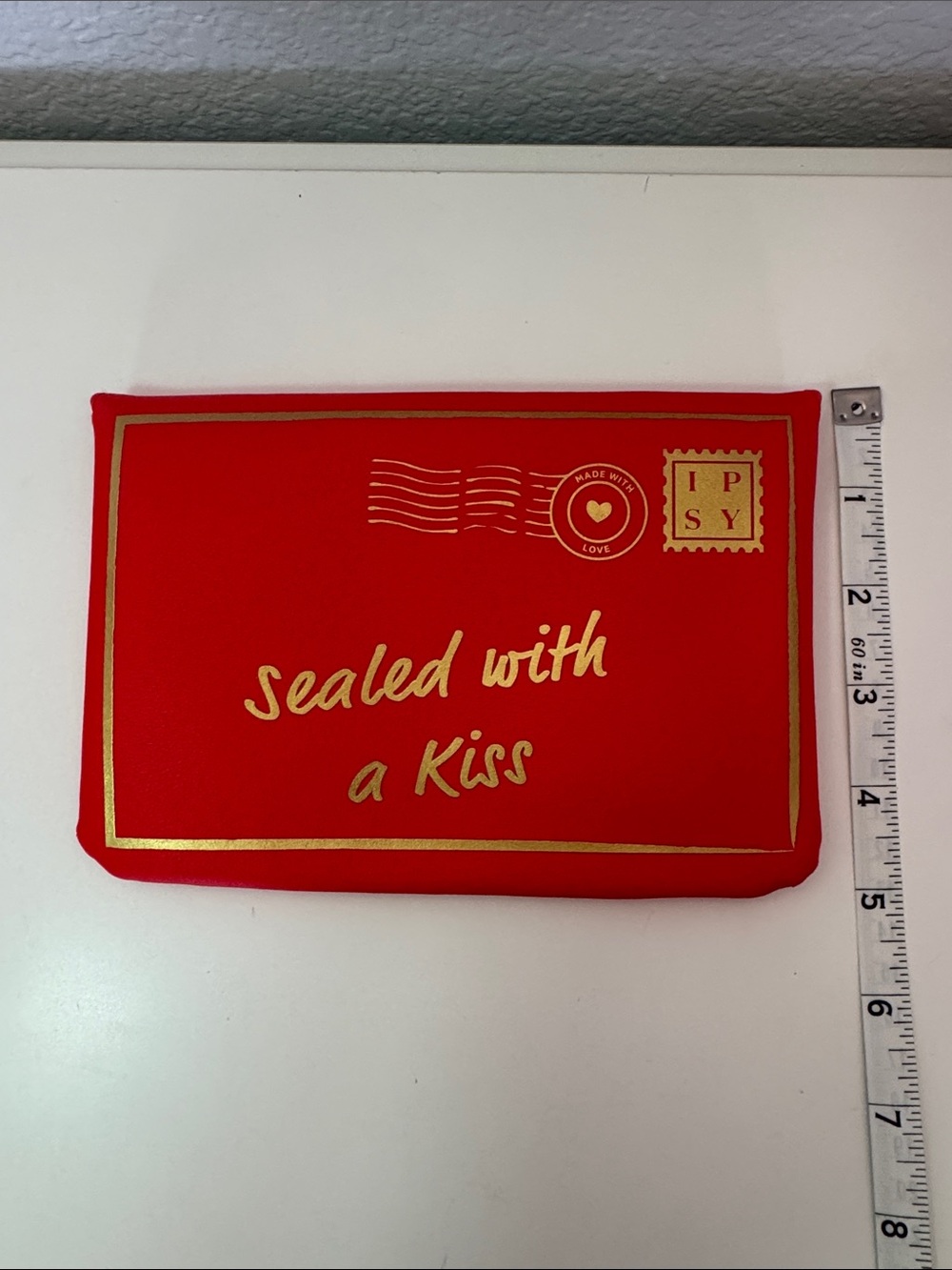 This is a red Ipsy Sealed with a Kiss makeup bag NWOT